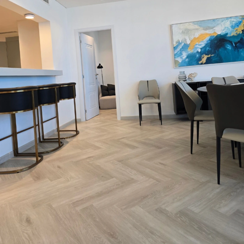 Light herringbone semi-solid flooring in a dining area